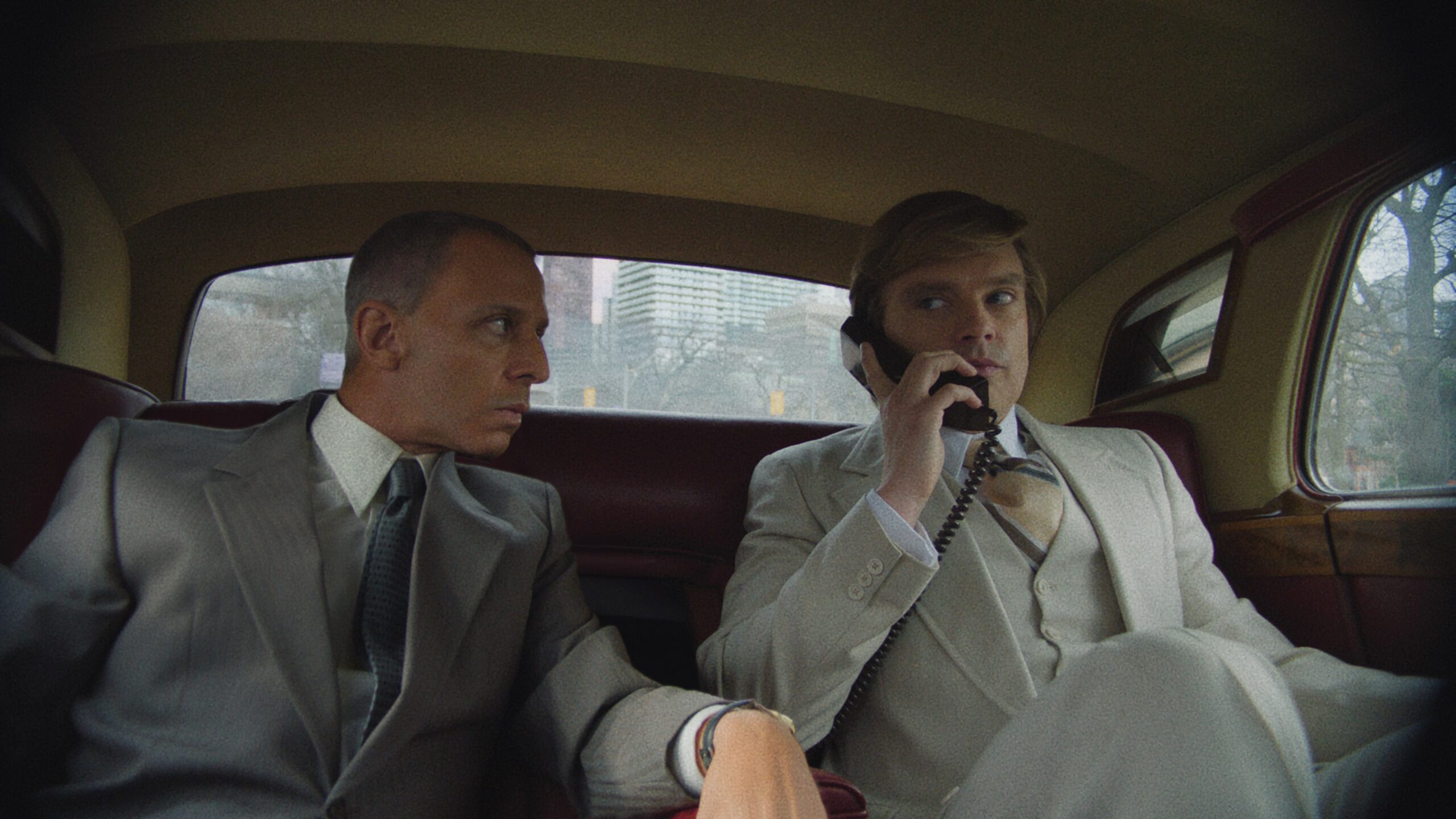 Sebastian Stan as 'Donald Trump' and Jeremy Strong as 'Roy Cohn' on the back seat of a car in 'The Apprentice' film