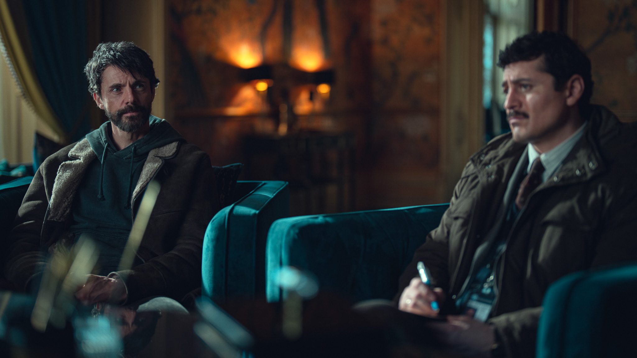 Matthew Goode and Alexej Manvelov sitting in chairs in 'Dept Q'