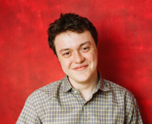 Actor headshot of Aaron Hodgett looking at camera