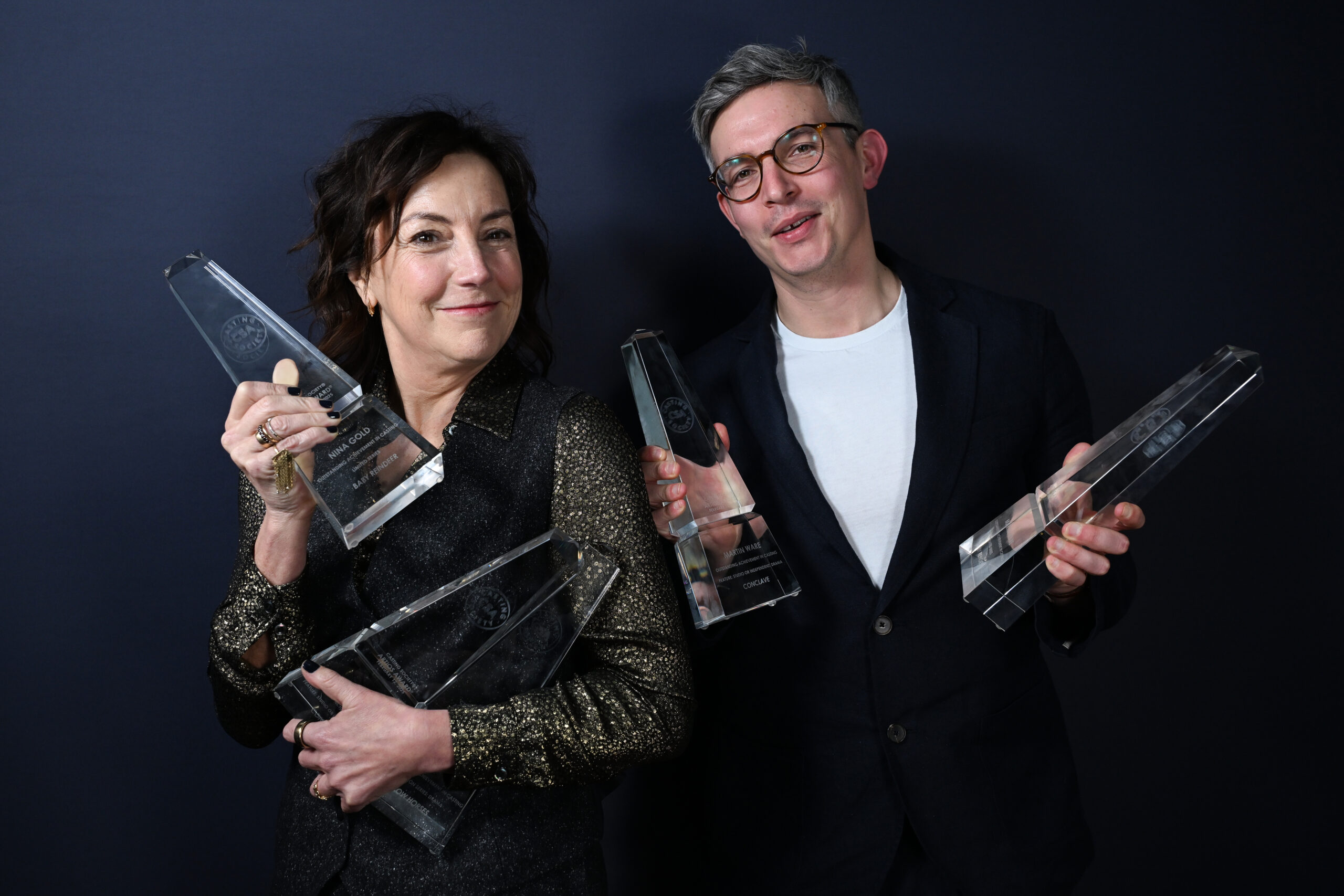Nina Gold and Martin Ware holding their multiple Artios Awards