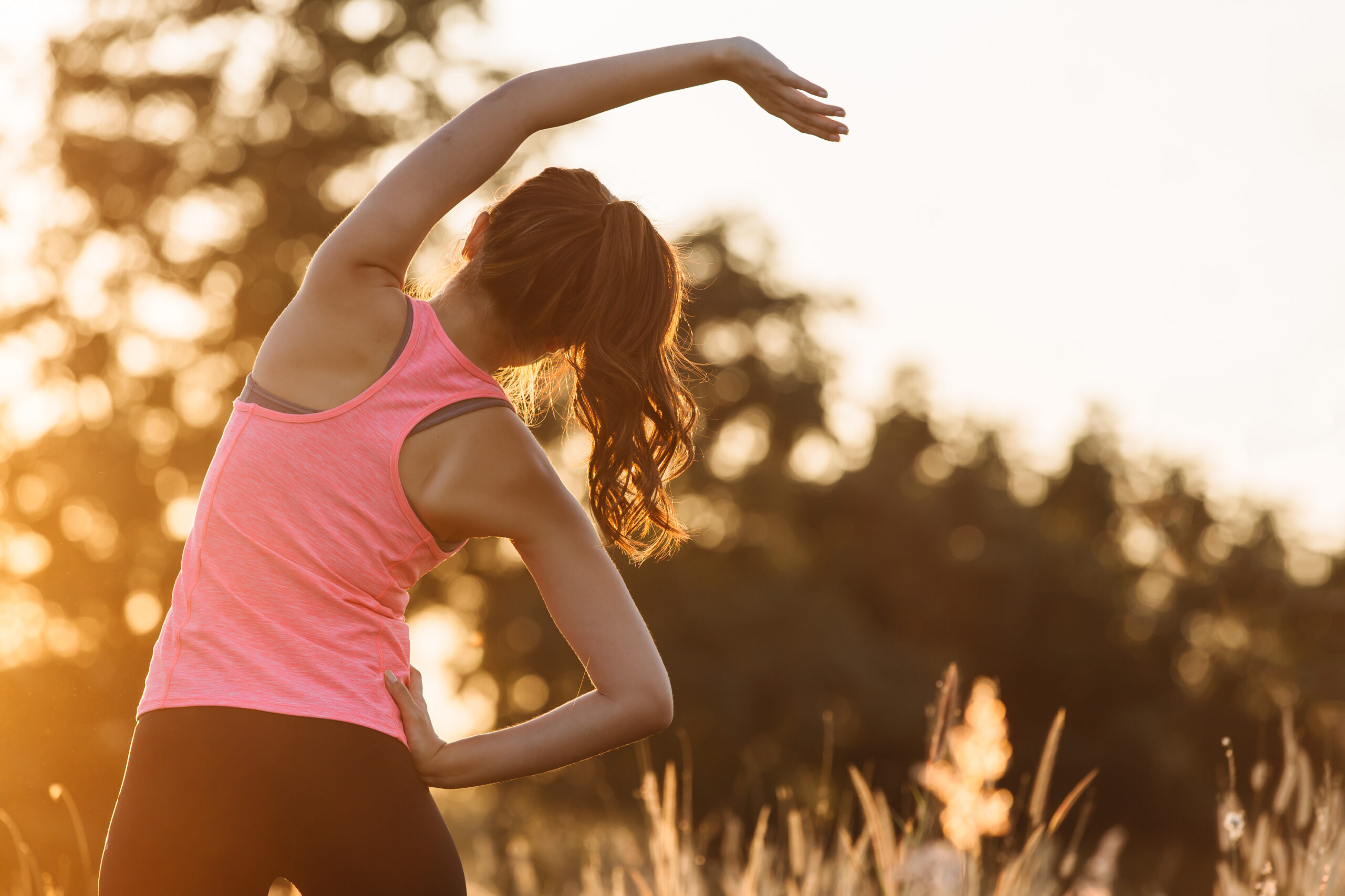 Young woman stretching before a workout at the park
