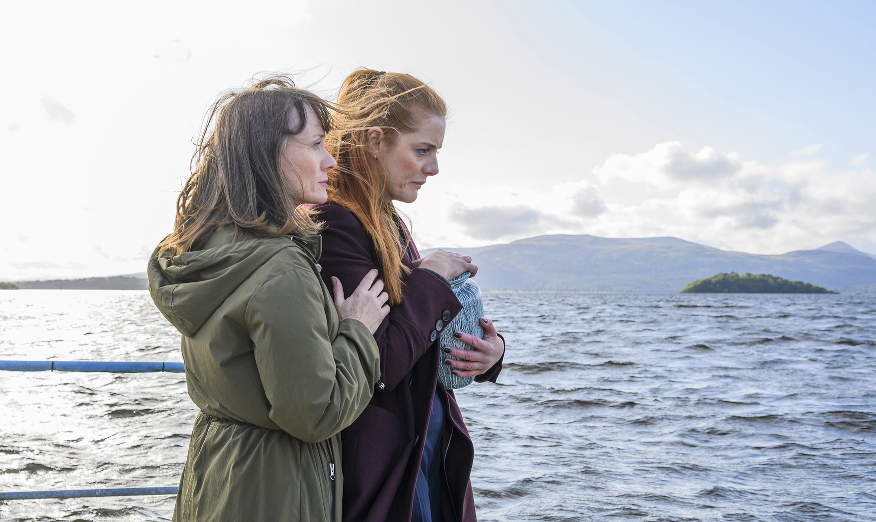 Eve Christie and Amber Murdoch standing by the water in 'River City'