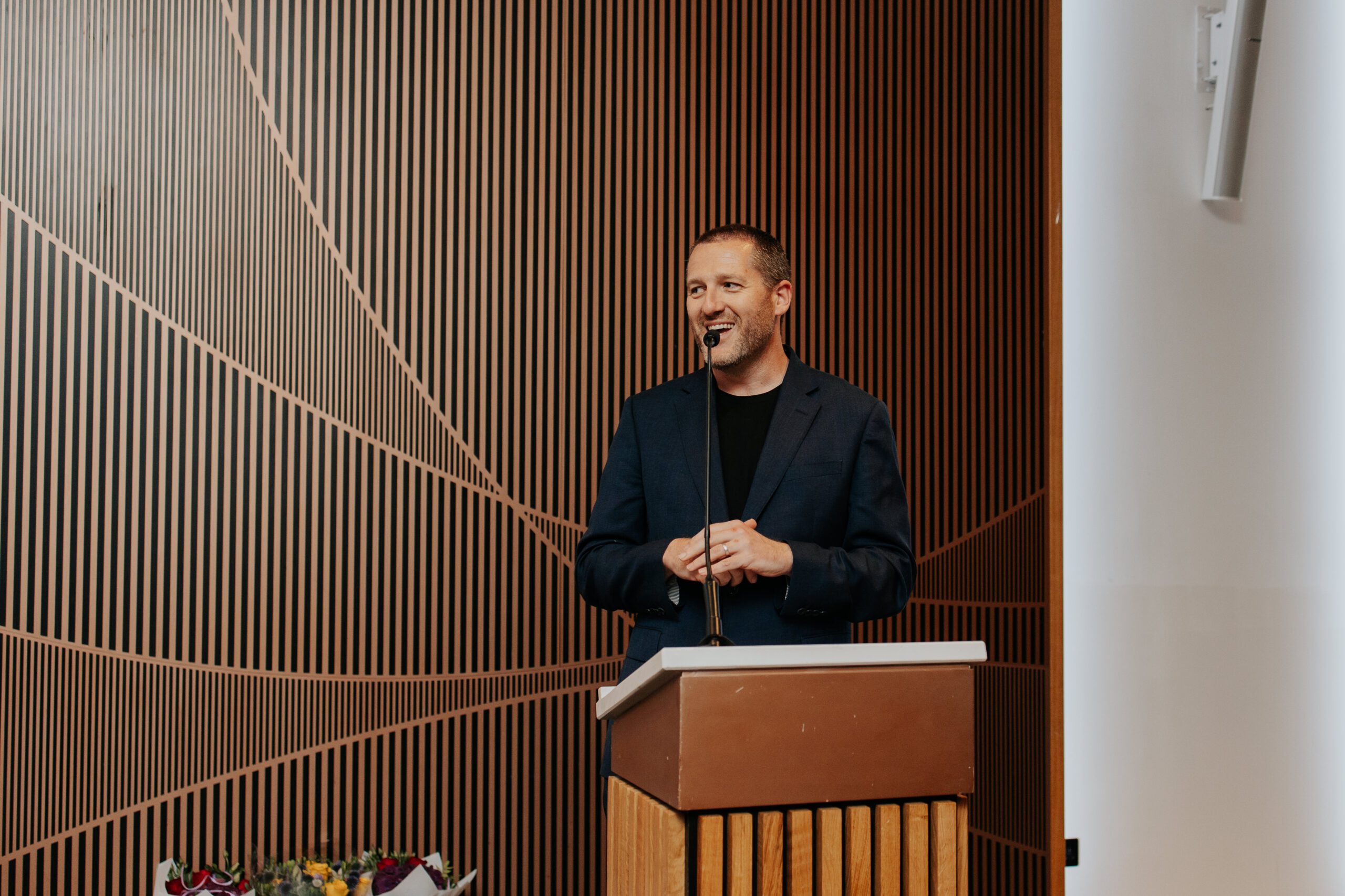 Spotlight MD Matt Hood speaking at a podium