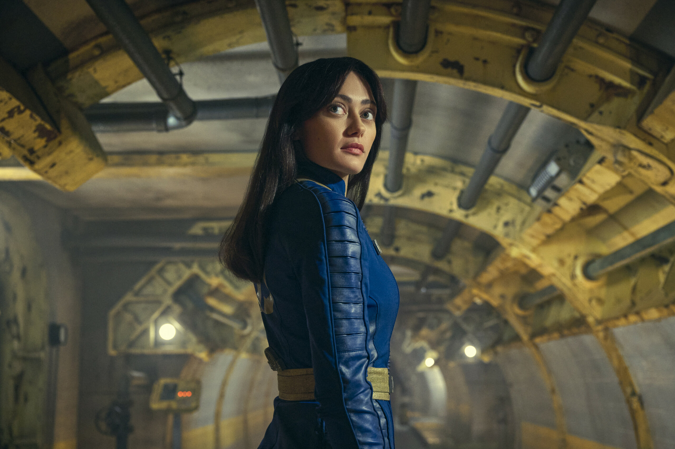 Ella Purnell as 'Lucy' in 'Fallout' in the Vault tunnel wearing a blue Vault jumpsuit
