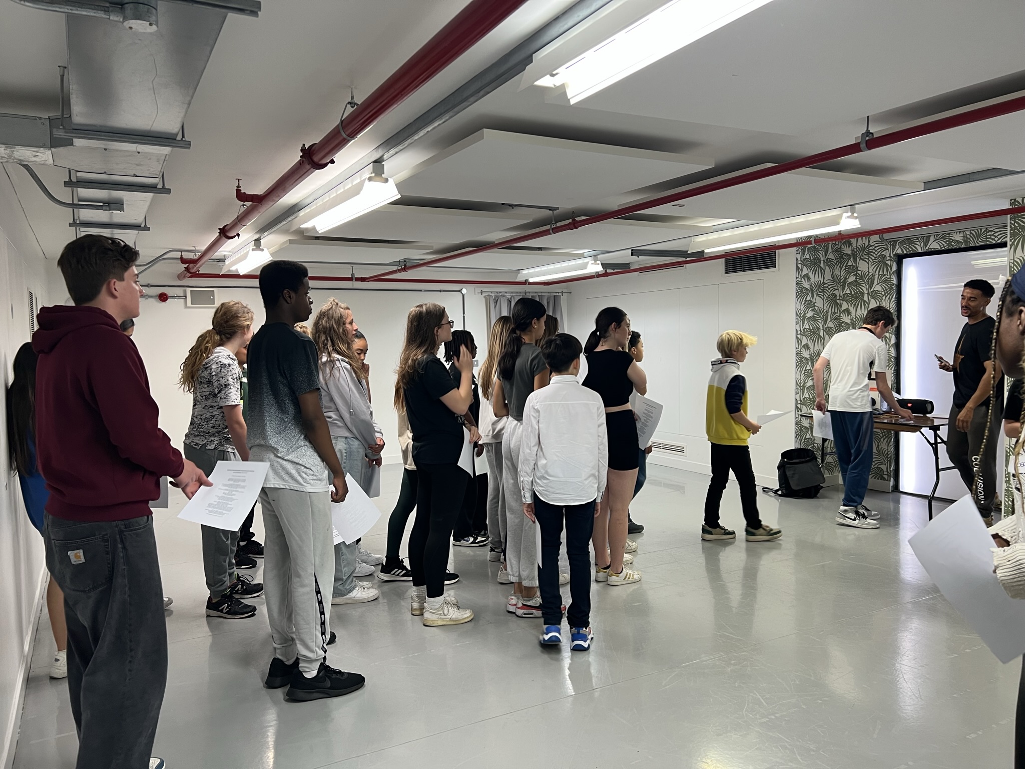 Room of young performers holding scripts participating in a Spotlight workshop