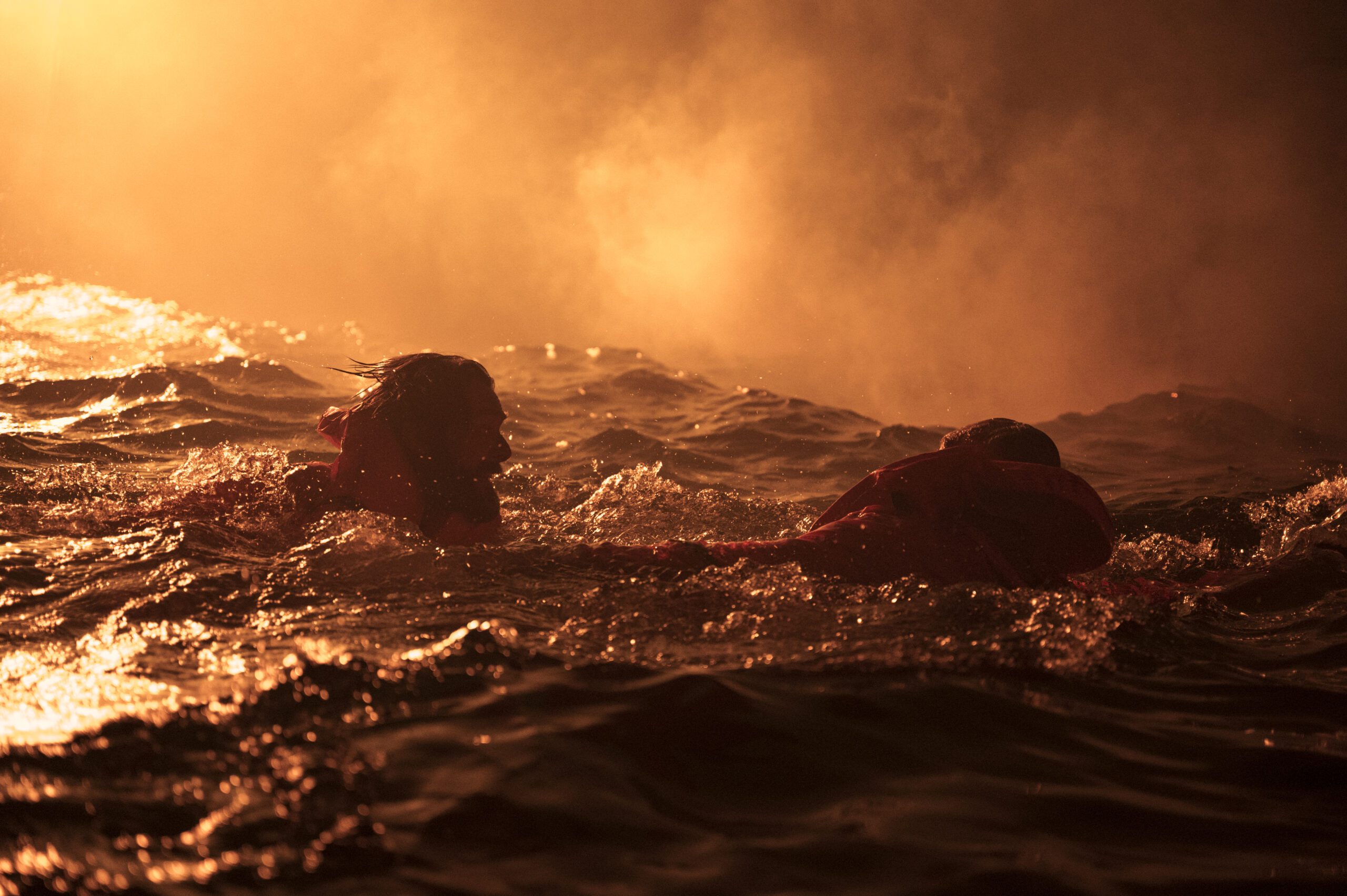 Actors portraying two people in the water during the Piper Alpha disaster in 'Disaster at Sea: The Piper Alpha Story'